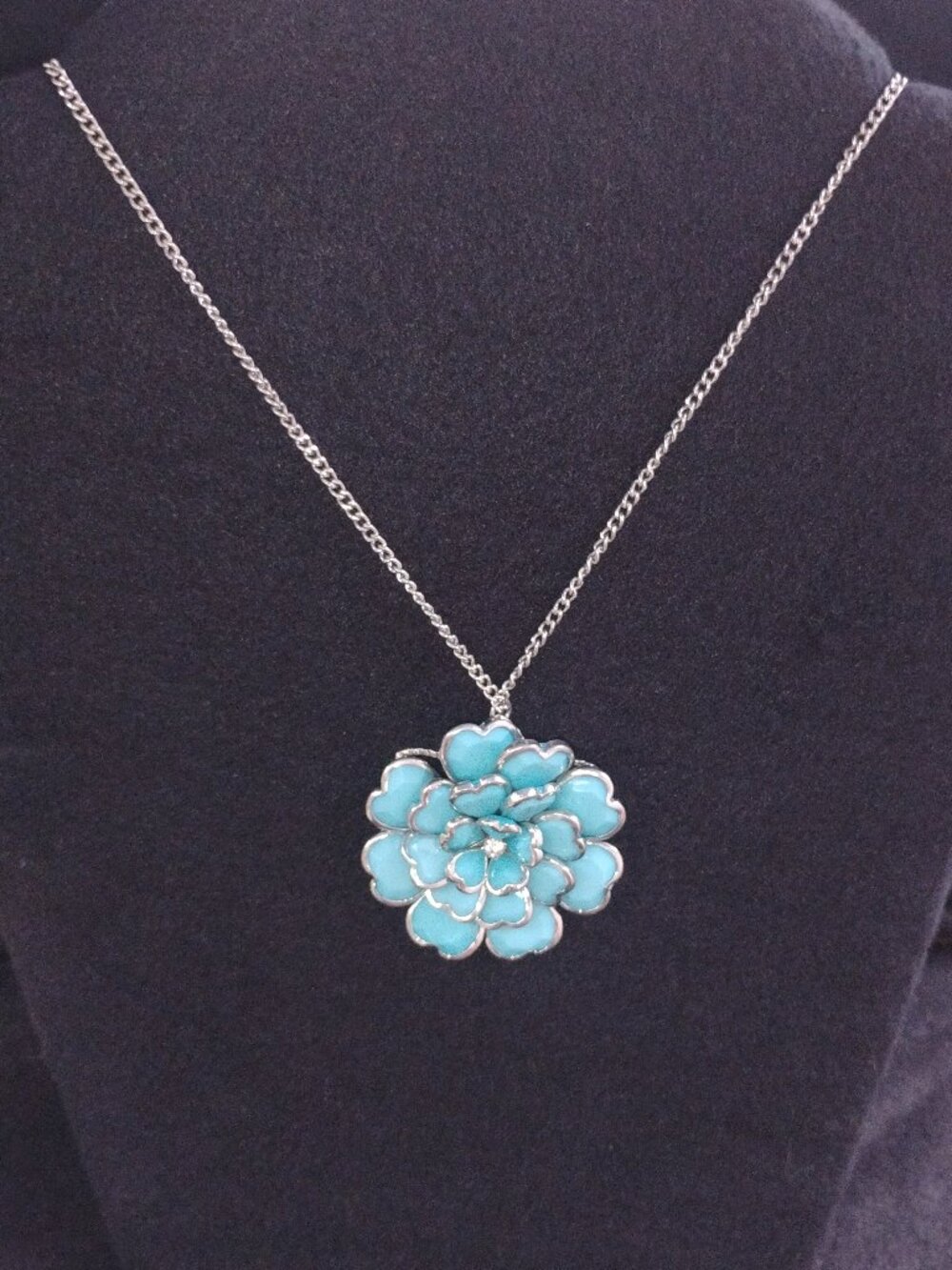 Turquoise-blue layered floral petal necklace.